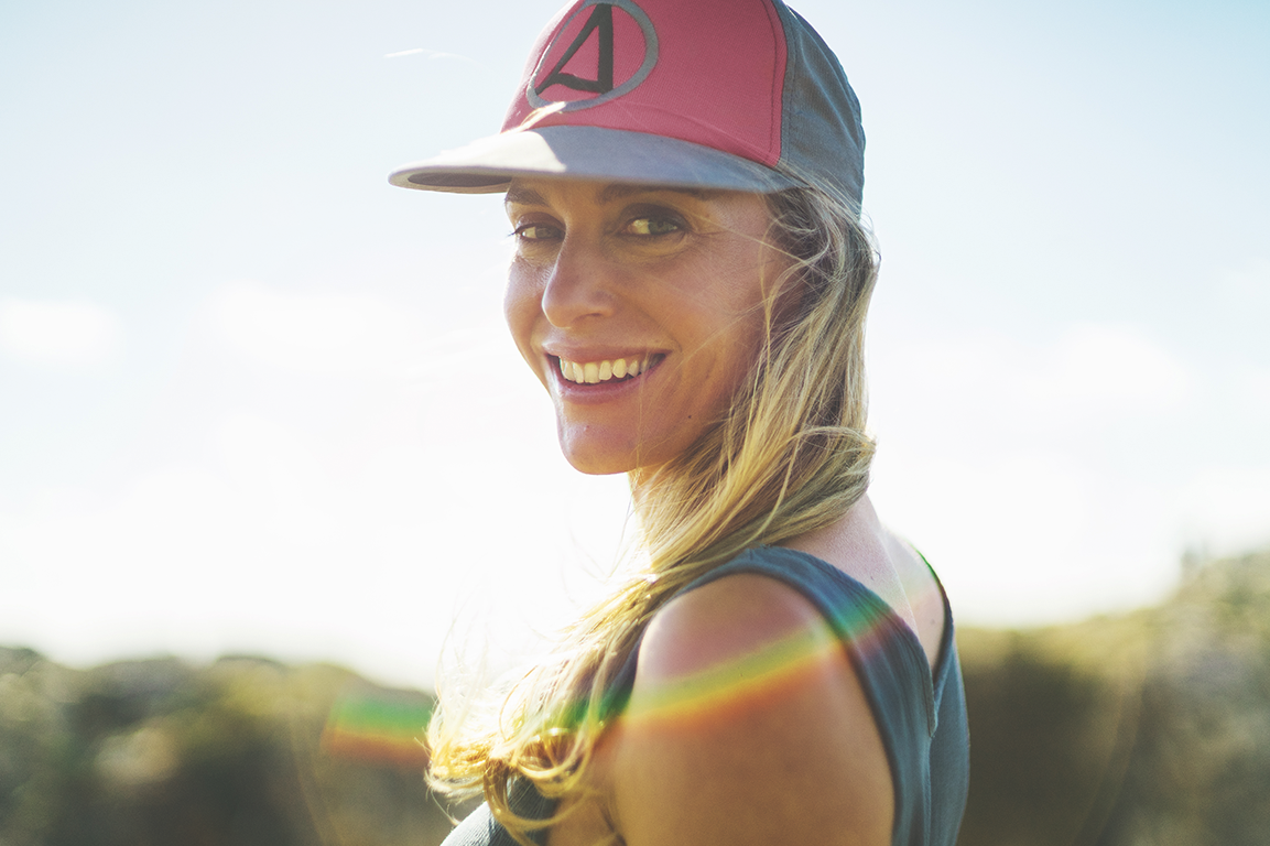 image of a girl smiling using a pink surf hat